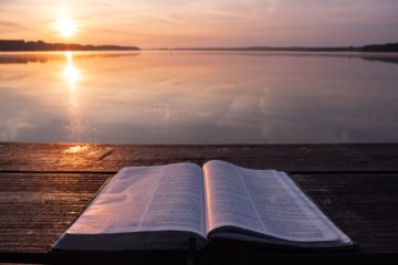 book on top of table and body of water