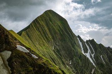 green mountain under cloudy sky